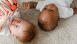 Babies Laying On Carpet